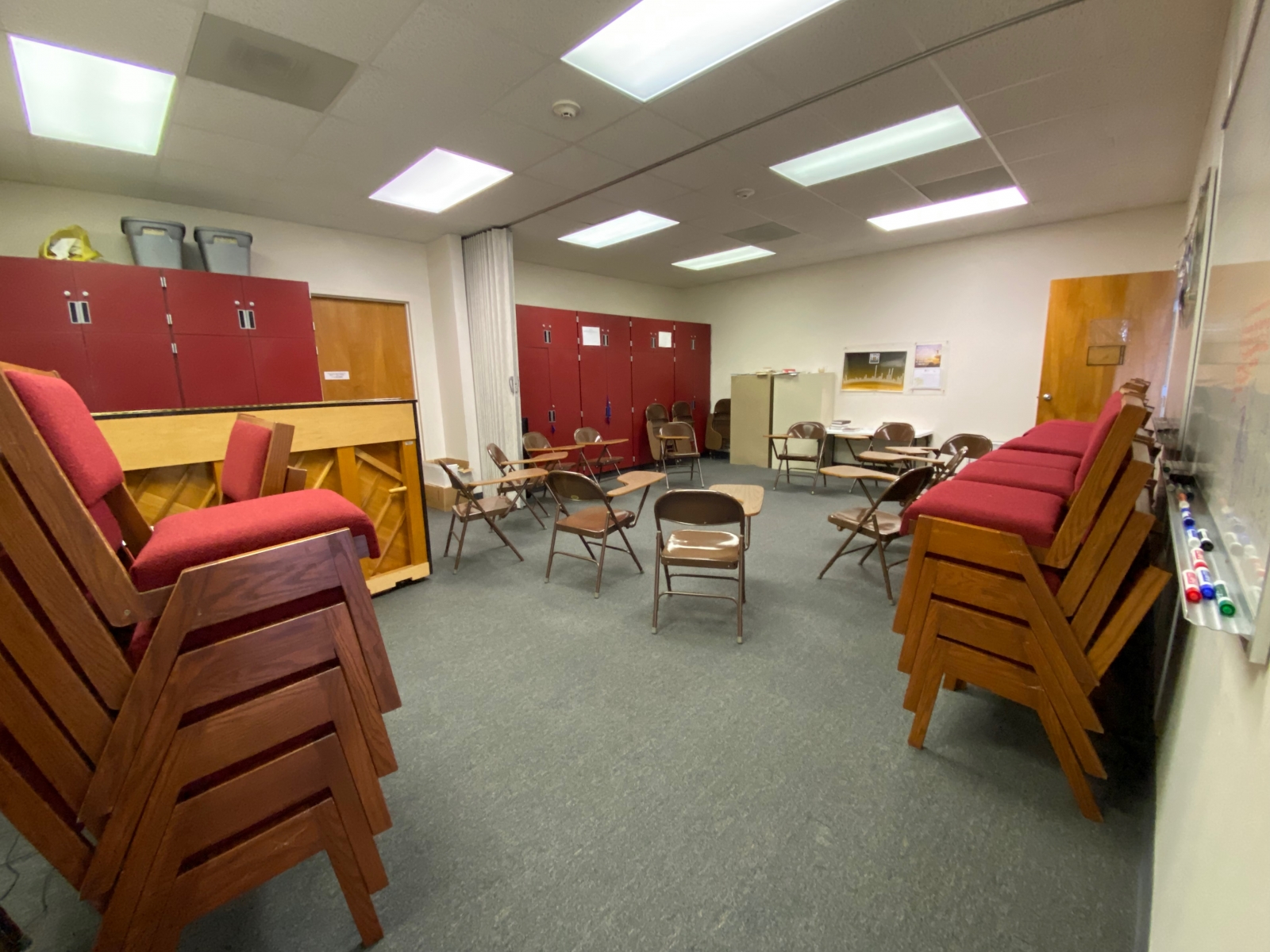 Room 214 has student desks and a piano.
